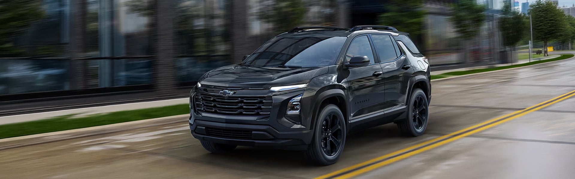 Dark grey Chevrolet Equinox driving through a city street